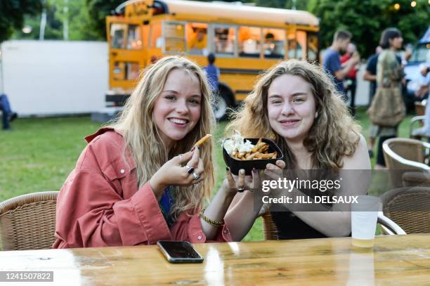 Two festival goers hold a reusable cup with fries , at the first day of the Genk on Stage free music festival in Genk, Friday 24 June 2022. BELGA...