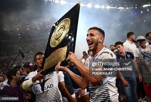 Montpellier's French wing Vincent Rattez and Montpellier's Australian hooker Brandon Paenga-Amosa celebrate with the Bouclier de Brennus trophy after...