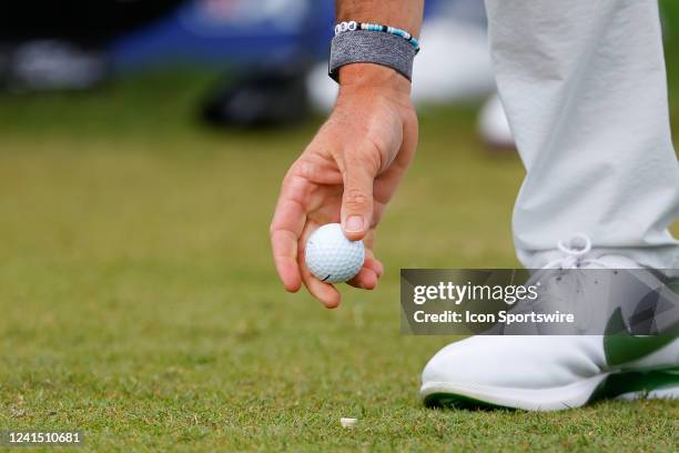 Rory McIlroy of Northern Ireland puts his Taylor Made 1 golf ball on the tee at the first hole during the second round of the Travelers Championship...