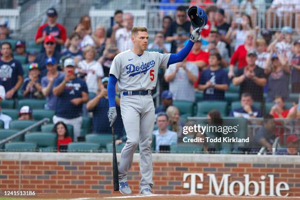 Freddie Freeman of the Los Angeles Dodgers tips his helmet during his return to Truist Park during the first inning against the Atlanta Braves at...