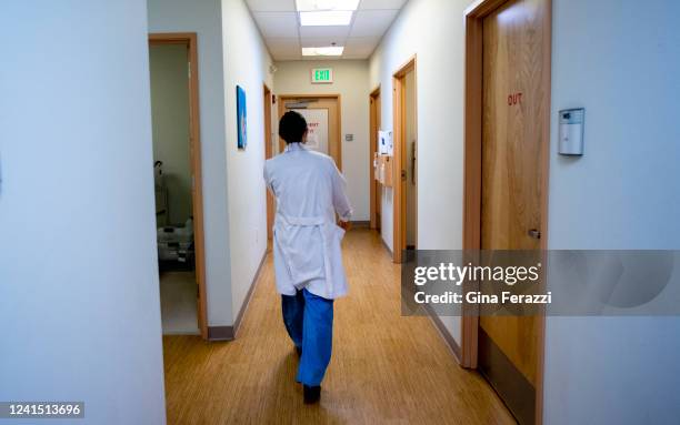 Dr. Lisa Hofler, the clinical vice chair of the Department of Obstetrics and Gynecology at the University of New Mexico walks towards an exam room to...