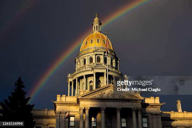 Rainbow forms above the Colorado State Capitol as people gather in protest of the Supreme Court's decision to overturn Roe v. Wade on June 24, 2022...
