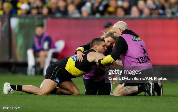 Dion Prestia of the Tigers is seen injured during the 2022 AFL Round 15 match between the Geelong Cats and the Richmond Tigers at the Melbourne...