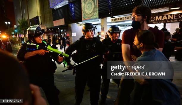 Police holding rubber-bullet guns and batons move to disperse a crowd of abortion rights activists protesting after the overturning of Roe Vs. Wade...