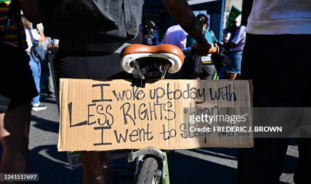 Sign attached to a bycicle reads "I Woke Up Today With Less Rights Than I Went To Sleep With" as abortion rights activists protest after the...