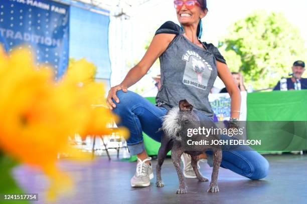 Jeneda Benally introduces her dog Mr. Happy Face on stage during the World's Ugliest Dog Competition in Petaluma, California on June 24, 2022. - Mr....
