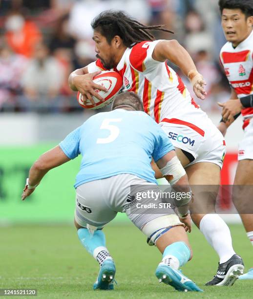 Japan's Shota Horie runs with the ball past Uruguay's Diego Magno during the Lipovitan D Challenge Cup 2022 rugby test match between Japan and...