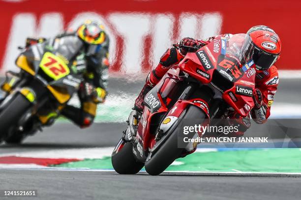 Aprilia Spain's rider Maverick Vinales and Ducati Lenovo Team Italian rider Francesco Bagnaia compete during MotoGP qualifying at the TT circuit of...