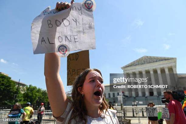 An abortion rights demonstrator holds a sign in front of the US Supreme Court in Washington, DC, on June 25, 2022. - Protesters were expected to pour...