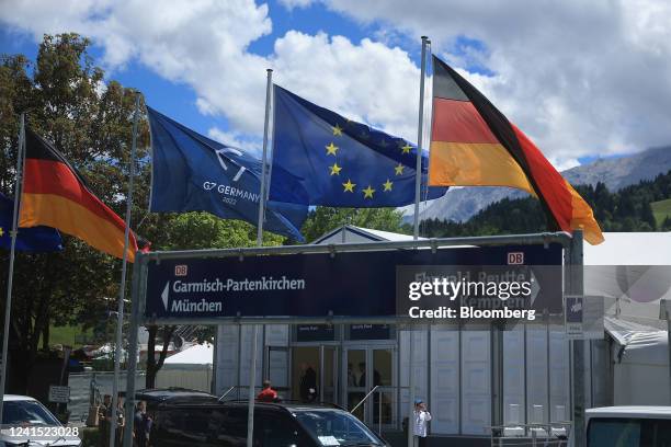 The flag for the Group of Seven , second left, flanked by the German national flag, left, and the European Union flag, second right, outside of the...