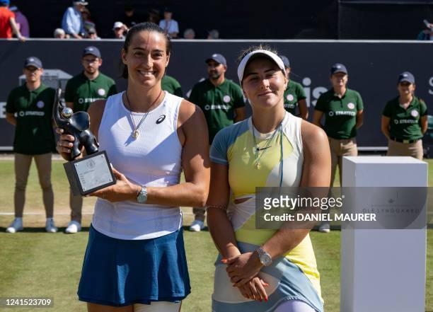 France's Caroline Garcia poses with the trophy after winning the 2022 WTA Bad Homburg Open tennis final match nex to Canada's Bianca Andreescu on...