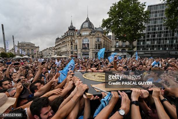 Supporters of Montpellier Herault Rugby celebrate with the Bouclier de Brennus during a ceremony a day after their team won the French Top 14 rugby...