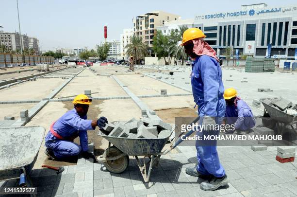 Foreign labourers work at a construction site in the Omani capital Muscat, amid scorching heat, on June 21, 2022. Between June and August, the...