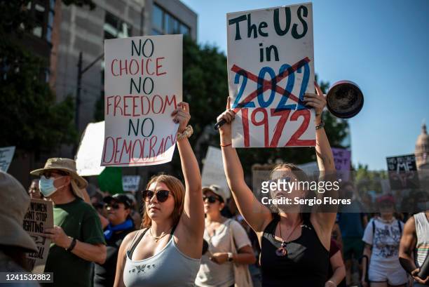 Protesters march while holding signs during an abortion-rights rally on June 25, 2022 in Austin, Texas. The Supreme Court's decision in Dobbs v...