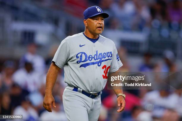 Manager, Dave Roberts of the Los Angeles Dodgers comes out to make a pitching change during the fifth inning against the Atlanta Braves at Truist...