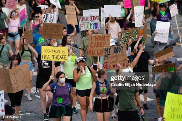 People march in the street during a protest against the Supreme Court's ruling in the Dobbs v Jackson Women's Health Organization on June 25, 2022 in...