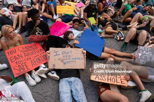 People protest outside the U.S. Court of Appeals for the Eleventh Circuit during a protest against the Supreme Court's ruling in the Dobbs v Jackson...