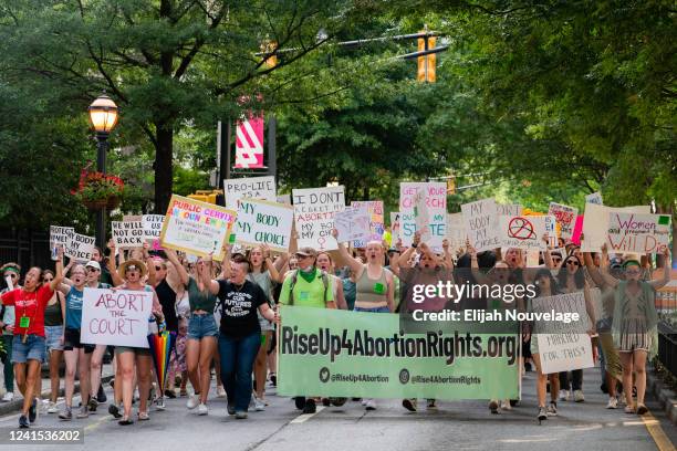 People march in the street during a protest against the Supreme Court's ruling in the Dobbs v Jackson Women's Health Organization on June 25, 2022 in...