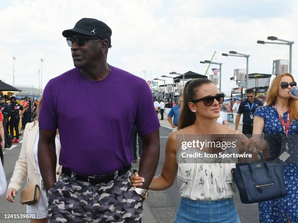 Hall of Fame and co-owner of 23XI racing Michael Jordan walks down pit road with his wife Yvette Prieto during qualifying for the running of the...