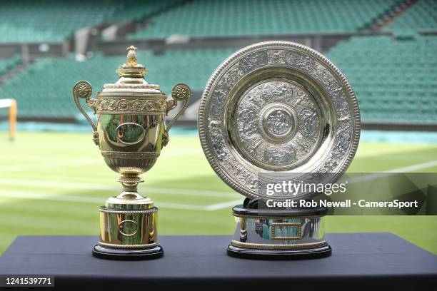 The Venus Rosewater Dish, the Ladies' Singles trophy and the Gentlemans Singles trophy ahead of The Championships Wimbledon 2022 at All England Lawn...