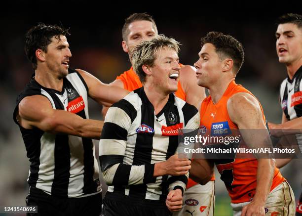 Jack Ginnivan of the Magpies and Josh Kelly of the Giants clash during the 2022 AFL Round 15 match between the Collingwood Magpies and the GWS Giants...