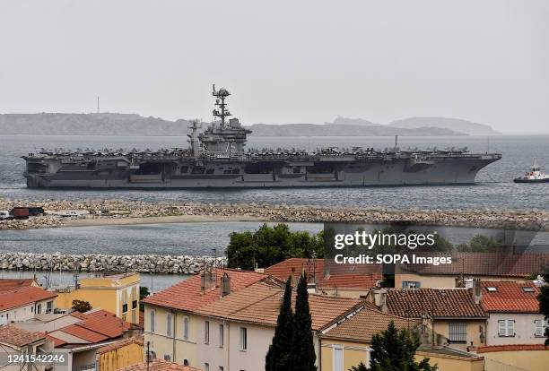 The aircraft carrier USS Harry S. Truman leaves in the French Mediterranean port of Marseille.