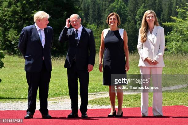 German Chancellor Olaf Scholz and his wife Britta Ernst greet British Prime Minister Boris Johnson and his wife Carrie Johnson during a welcome...