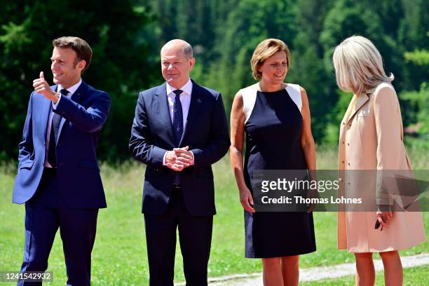 German Chancellor Olaf Scholz and his wife Britta Ernst greet French President Emmanuel Macron and his wife Brigitte Macron during a welcome ceremony...