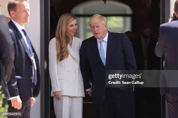 British Prime Minister Boris Johnson and wife Carrie Johnson walk to the first working session on the first day of the three-day G7 summit at Schloss...