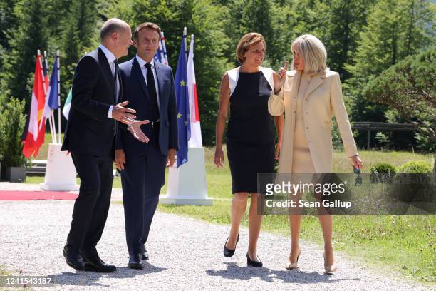 German Chancellor Olaf Scholz and wife Britta Ernst walk with French president Emmanuel Macron and wife Brigitte Macron walk to the first working...