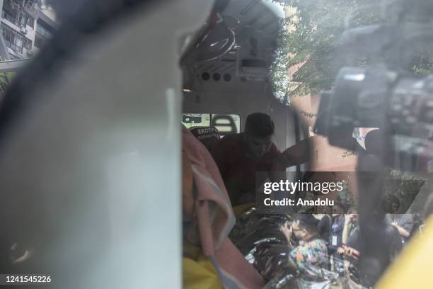 Female survivor receives medical aid into an ambulance at the scene of a residential building following explosions in a neighborhood in north of...