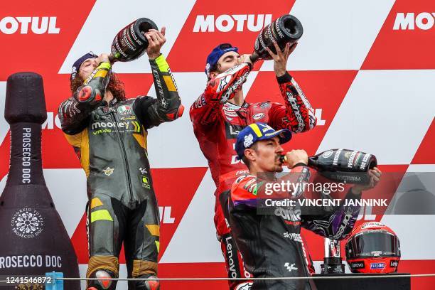 Italy's rider Marco Bezzecchi , Italy's Francesco Bagnaia, and Spain's Maverick Vinales celebrate after the Dutch Moto GP race at the TT circuit in...