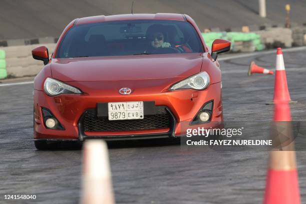 Afnan Almarglani, the first Saudi woman to be certified as an autocross instructor, drives her car at Derab circuit in the capital Riyadh on June 26,...
