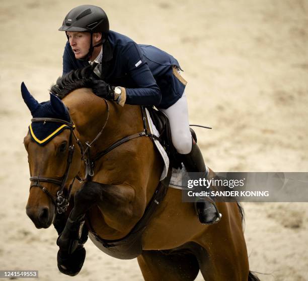 Ireland's Daniel Coyle riding Legacy competes in the FEI Jumping Nations Cup at CHIO in Rotterdam, on June 26, 2022. - The equestrian takes place for...