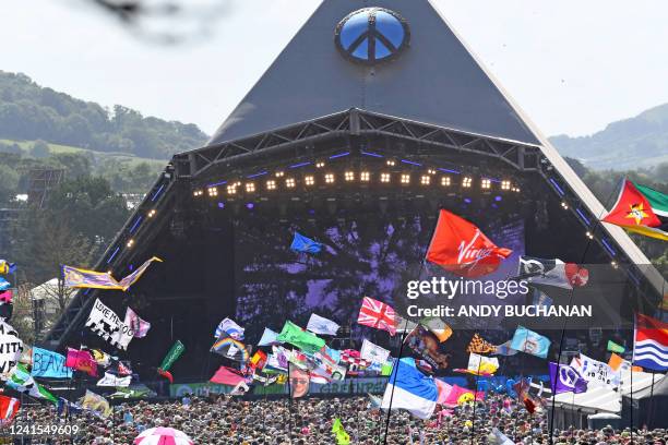 Festivalgoers watch US legend Diana Ross perform on the Pyramid Stage at the Glastonbury festival near the village of Pilton in Somerset, south-west...