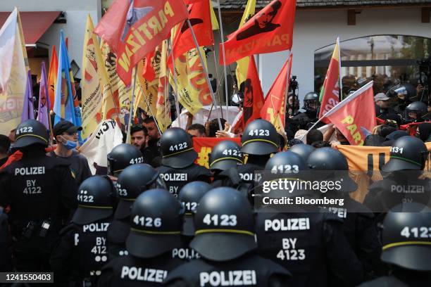 Police officers observe demonstrators protesting against the Group of Seven leaders summit on the first day of summit, in Garmish-Partenkirchen,...