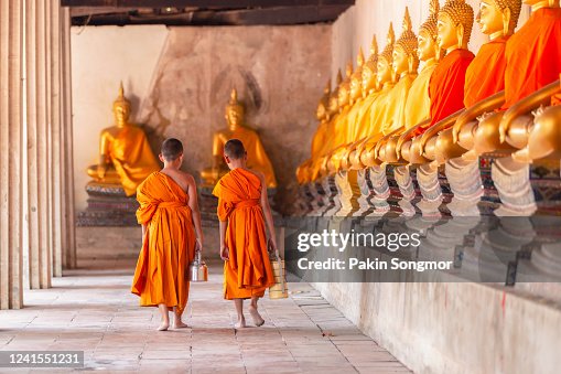 Two novices walking return and talking in old temple Two novices walking return and talking in old temple