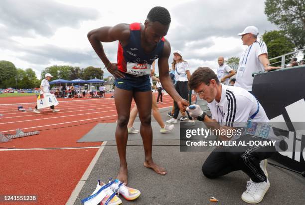 Medical staff measures blood sugar level of France's Thomas Jordier at the end of the mens 400 metre final during the French Elite Athletics...