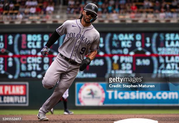 Connor Joe of the Colorado Rockies runs to third base on his way to scoring a run in the first inning of the game against the Minnesota Twins at...