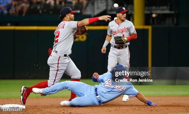 Marcus Semien of the Texas Rangers is out at second base as Luis Garcia of the Washington Nationals throws to first base to complete the double play...