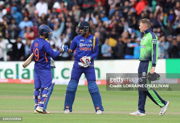 India's Dinesh Karthik and India's Deepak Hooda celebrate their win in the Twenty20 International cricket match between Ireland and India at Malahide...