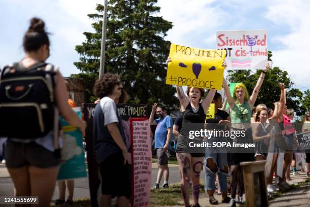 Counter protesters hold placards in favor of abortion and against an anti-abortion prayer circle. Protesters came to disrupt a prayer rally praying...