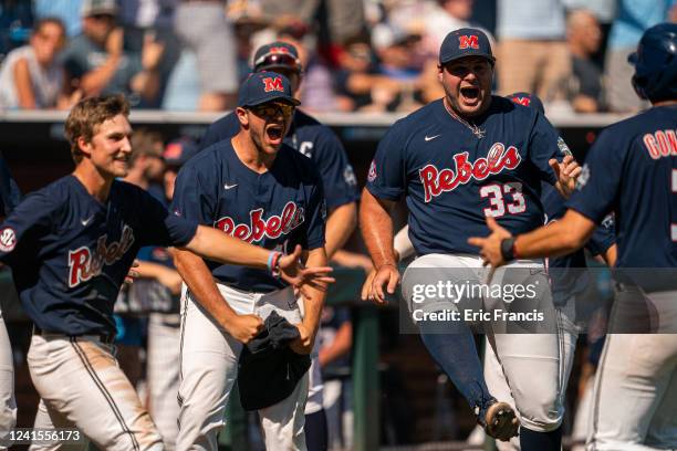 Ben Van Cleve and Dylan DeLucia of the Ole Miss Rebels celebrate taking the lead during Men's College World Series game at Charles Schwab Field on...