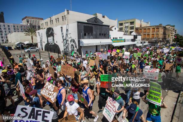 Protesters hold placards during a demonstration in downtown Los Angeles on June 26 two days after the US Supreme Court released a decision on Dobbs v...