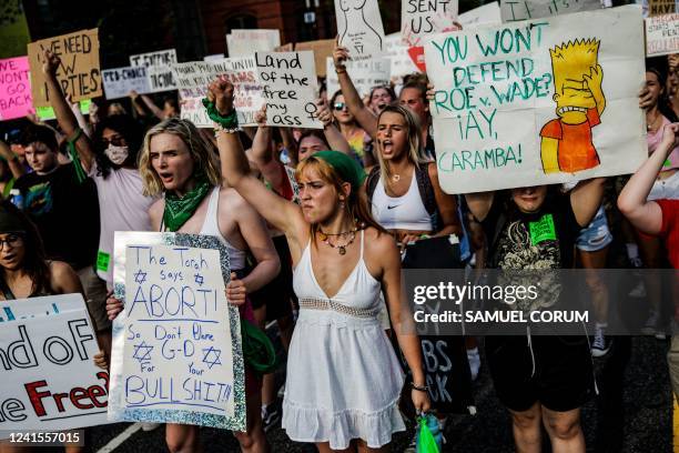 Abortion rights activists hold up fists as they protest in Washington, DC, on June 26 two days after the US Supreme Court scrapped half-century...