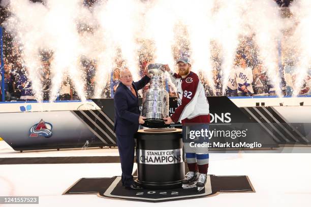 Gabriel Landeskog of the Colorado Avalanche celebrate winning the Stanley Cup with NHL Deputy Commissioner Bill Daly after Game Six of the 2022...