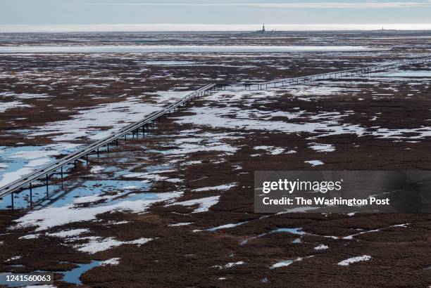 Oil pipelines stretch across the landscape outside Nuiqsut, AK where ConocoPhillips operates the Alpine Field on May 28, 2019.