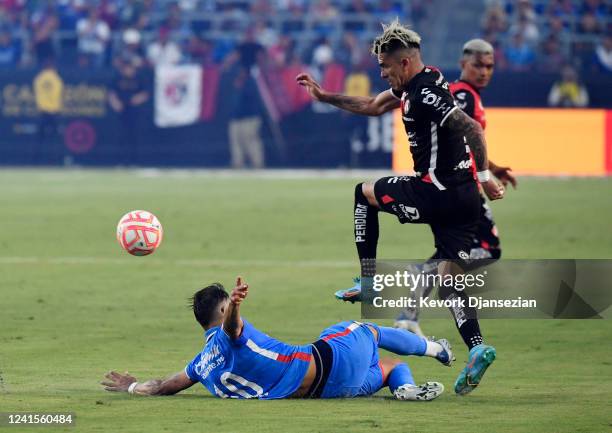 Angel Romero of Cruz Azul slide tackles against Luis Reyes Atlas during the second half of Campeon de Campeones 2022 soccer match at Dignity Health...