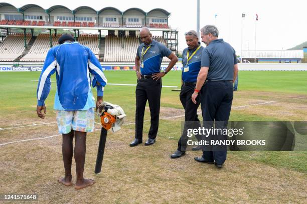 Match officials Gregory Brathwaite , Joel Wilson and Richard Illingworth inspect the pitch after rain delayed the start of the 4th day of the 2nd...