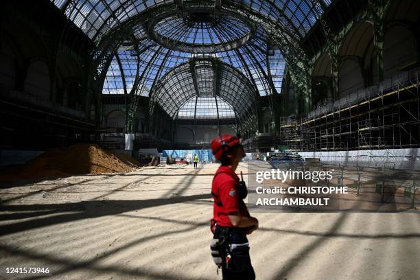 Worker walks in the under-restoration Grand Palais and its glass nave in Paris on June 27, 2022.